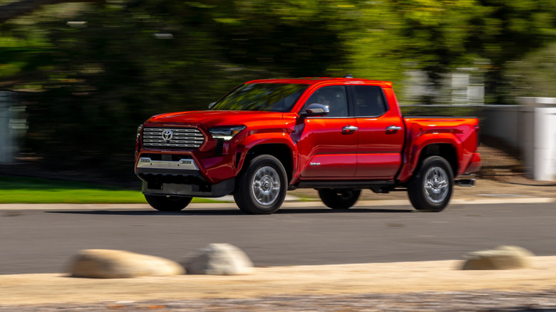 Red 2024 Toyota Tacoma driving on street