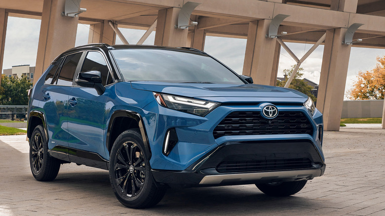 Blue Toyota RAV4 hybrid parked in a large structure