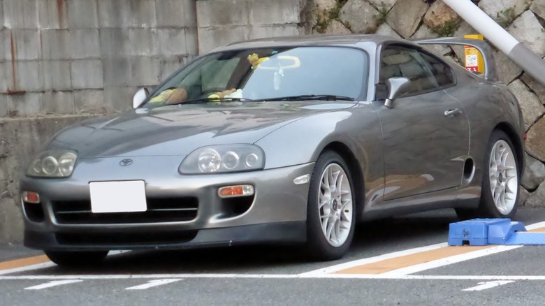 Gray JDM Toyota Supra Mk IV parked in bay.