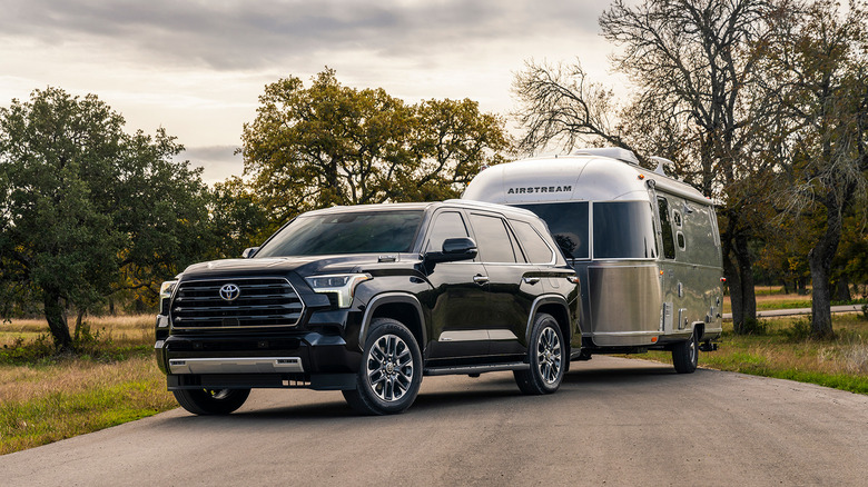 A black 2023 Toyota Sequoia towing an Airstream