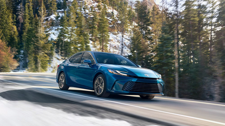 A blue 2025 Toyota Camry driving