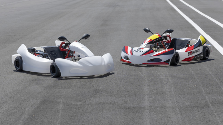 Front 3/4 view of two Gazoo Racing GR Karts in track setting, one with GR trim and one plain