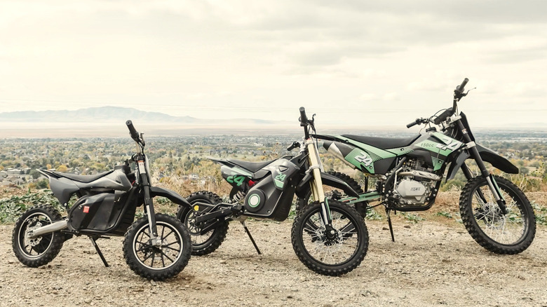Various Drift Hero dirt bikes displayed with a mountain range in the distance