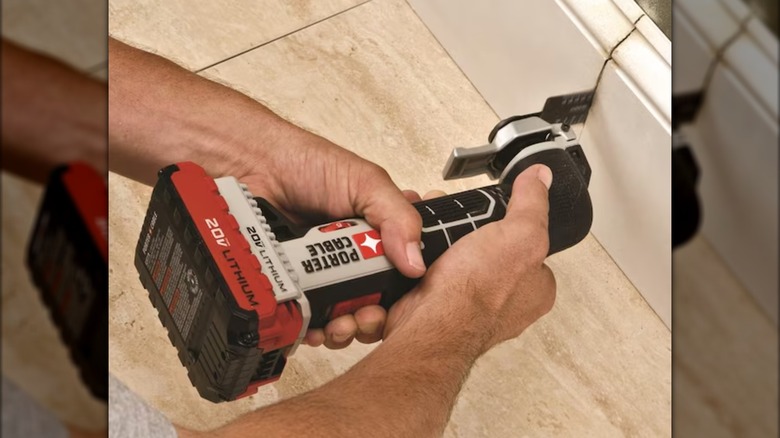 Cutting baseboard with Porter-Cable oscillating multitool.