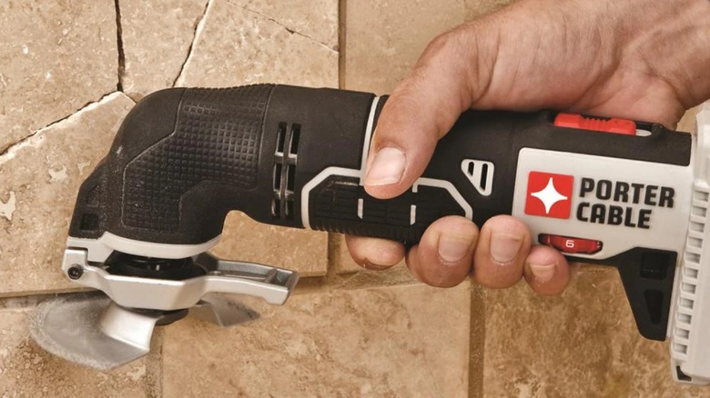 Cutting tile grout with Porter-Cable oscillating multitool.