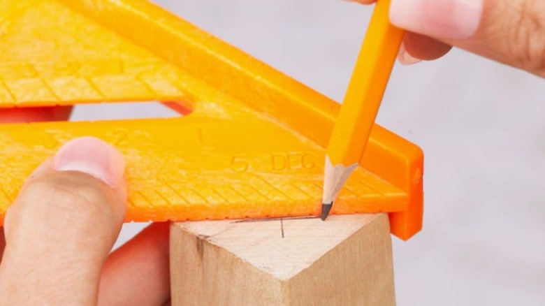 Marking an angle on the end of a board with Swanson speedlite square.