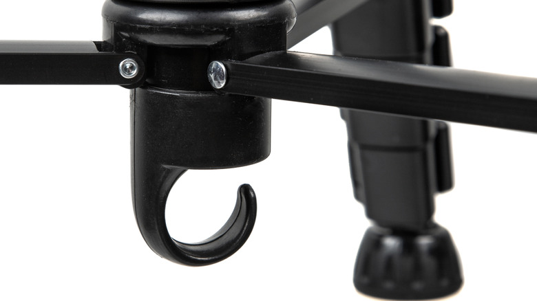 close-up of the hook on the bottom of the center pole of a tripod