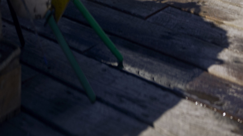 Rear 3/4 view of Triumph Thruxton 400 parked on wooden planks