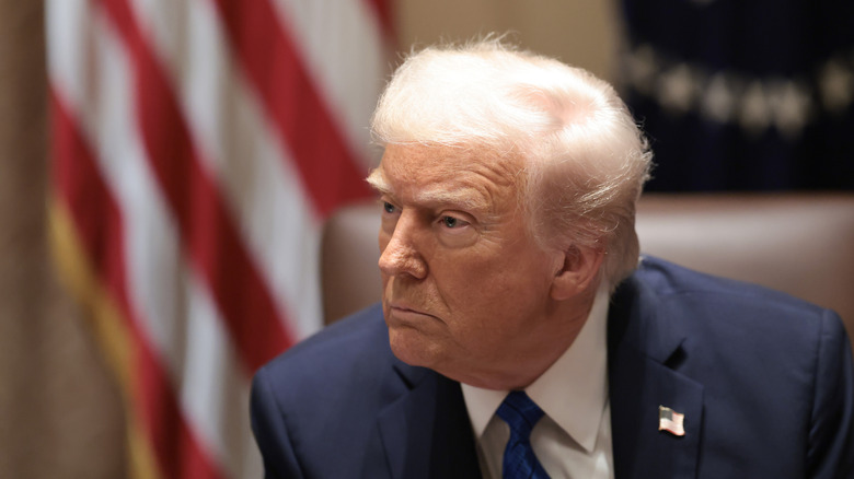 President Donald Trump listening to a media question.