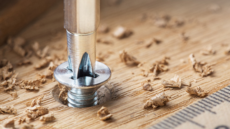 Driving a screw into a wooden surface