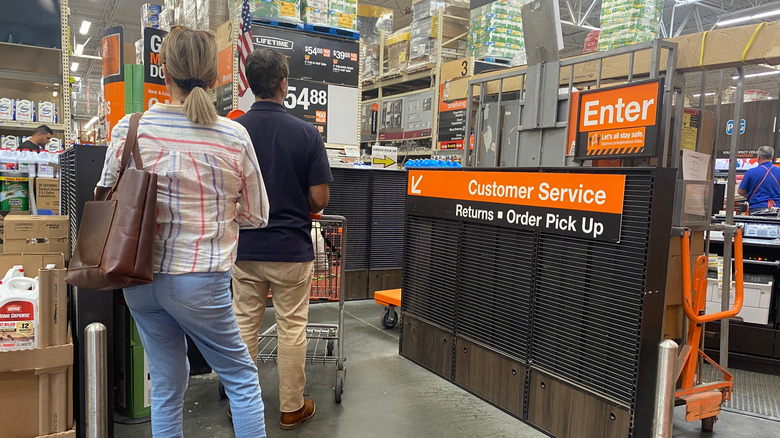 Customers in line at customer service inside a Home Depot store