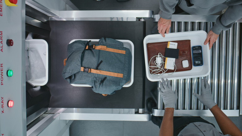 Ariel view of backpack and laptop on TSA conveyor belt