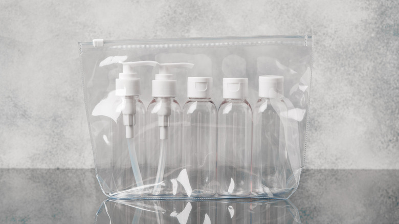 five travel size containers inside a clear plastic bag
