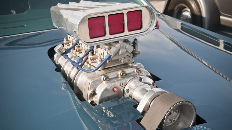 Roots supercharger poking through car hood