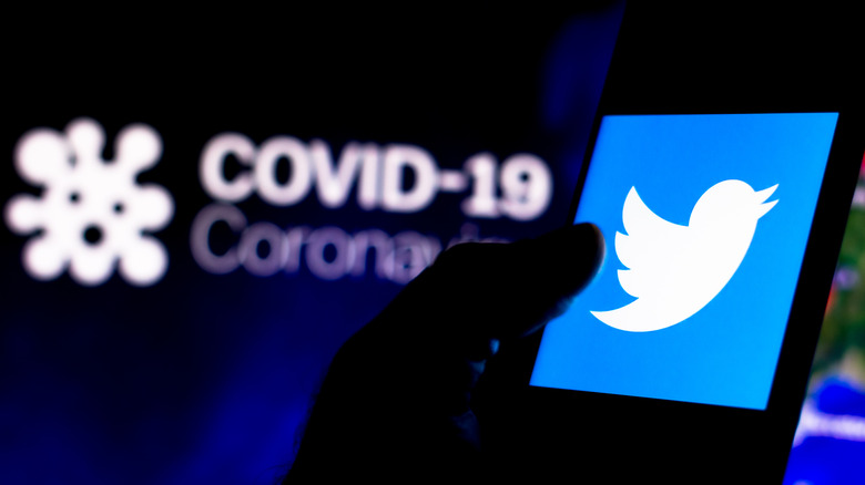 covid smartphone twitter logo dark