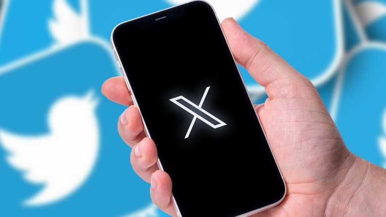 X logo on phone surrounded by Twitter logos