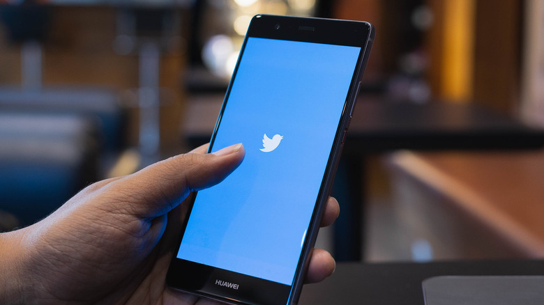 Twitter on smartphone in hand