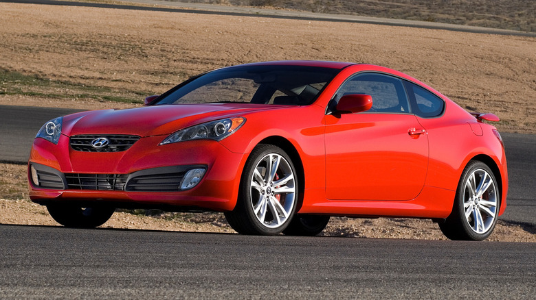 Red Hyundai Genesis Coupe parked on a road