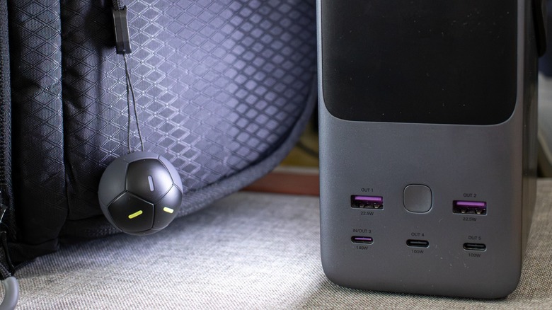 the Ugreen FineTrack 2 hanging from a camera sling bag