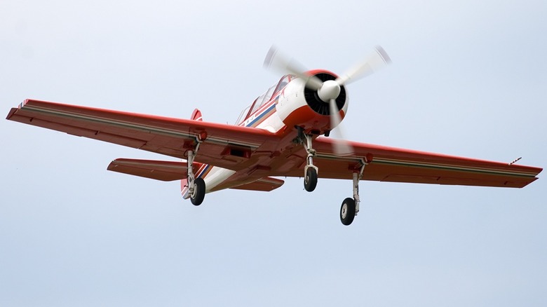 Red and white Yak-52 in flight