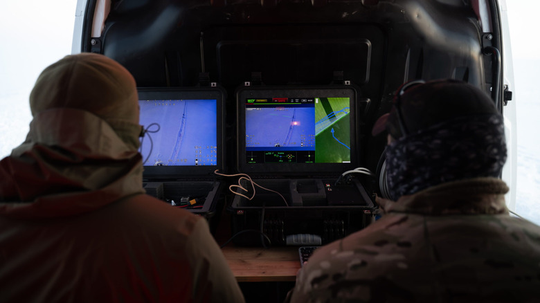 Two military drone operators watching a live feed from a Strila drone