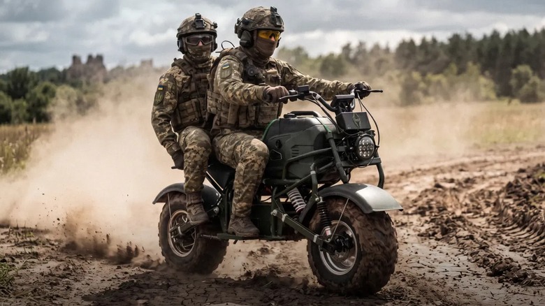 Two soldiers riding the MUL.E all-wheel-drive electric motorcycle on a muddy road