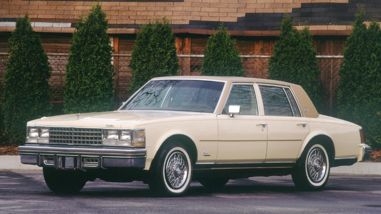 A pale blue Cadillac Seville from 1976.