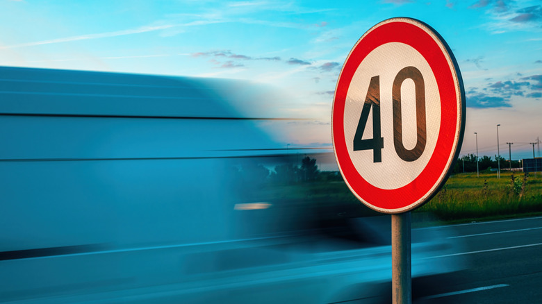 Sign showing 40 mph speed limit with a van driving past in the background