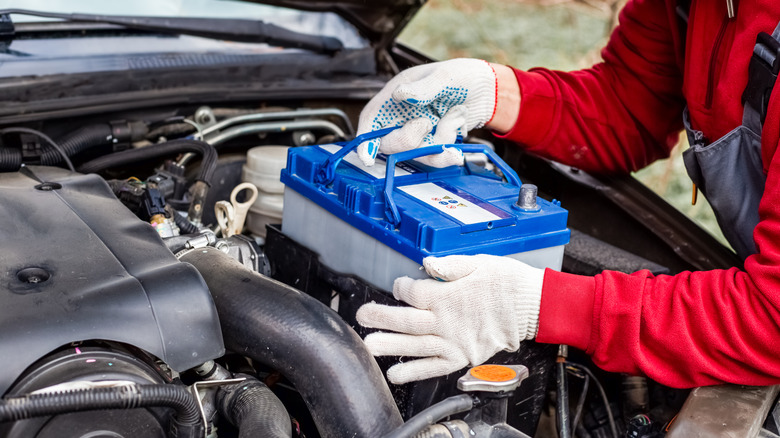 Mechanic installing a car battery