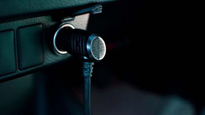 An adapter plugged into a car's 12V outlet