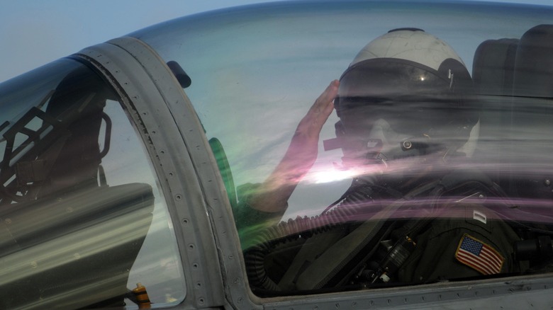 The pilot of an F/A-18C Hornet salutes the catapult officer prior to takeoff from the USS Ronald Reagan.