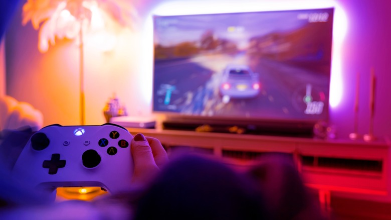 Someone playing Xbox game in colorful room