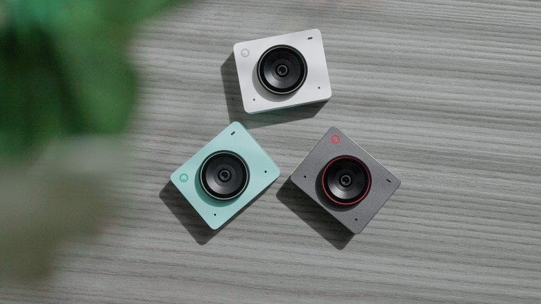 OBSBOT Meet 2 webcam in three colors -- light blue, white, and light gray.