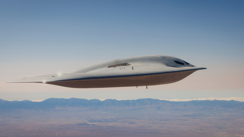 The B-21 bomber flying over a desert