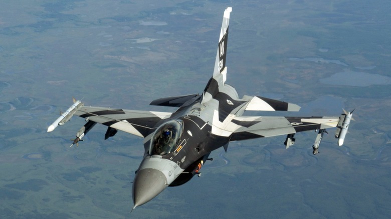 An F-16 Fighting Falcon in flight viewed from above.