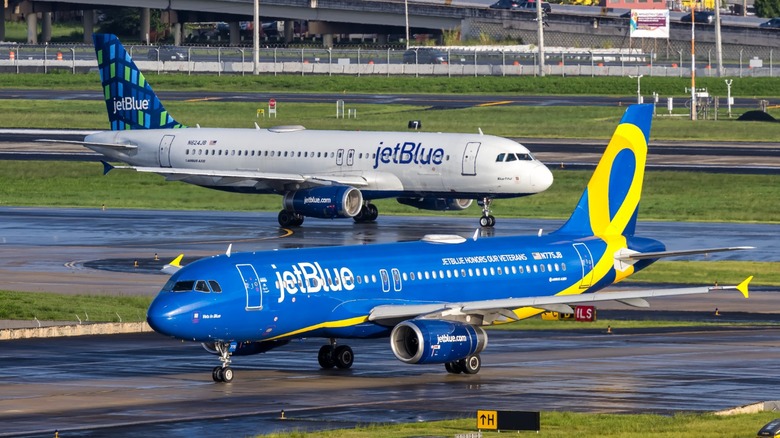 two JetBlue Airbus A320 family planes on the tarmac