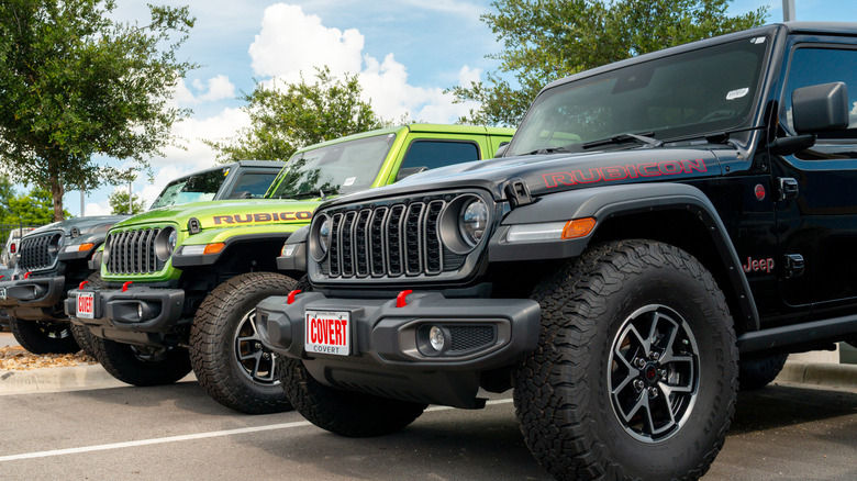 Several Jeep Wranglers parked outside.