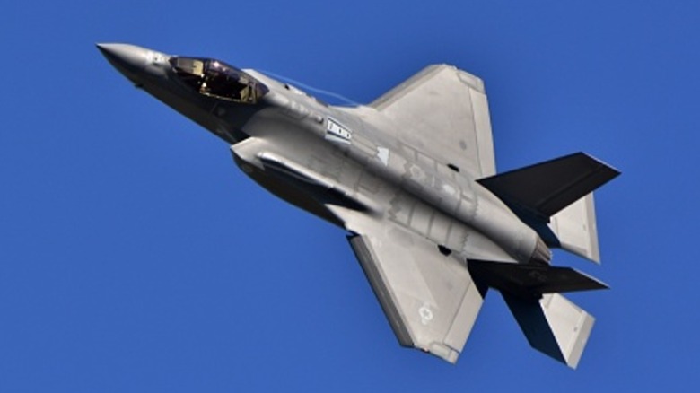 Lockheed Martin F-35 Lightning II climbing into a blue sky