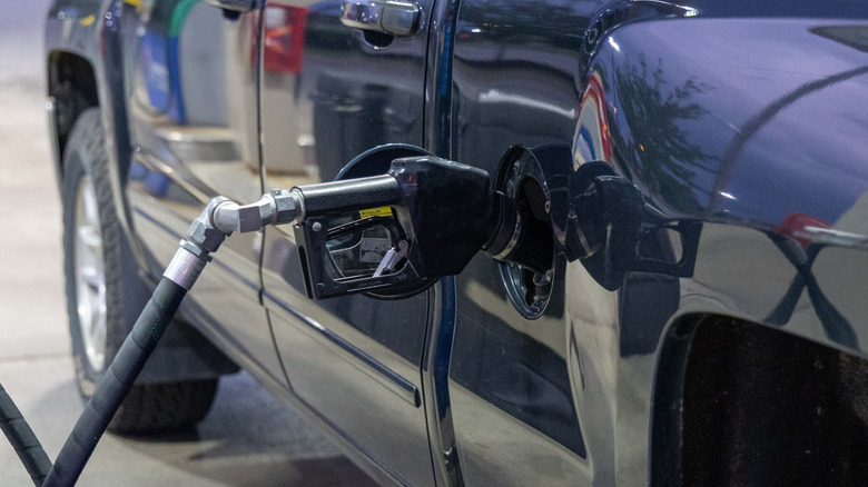 Gas pump handle sticking out of parked vehicle