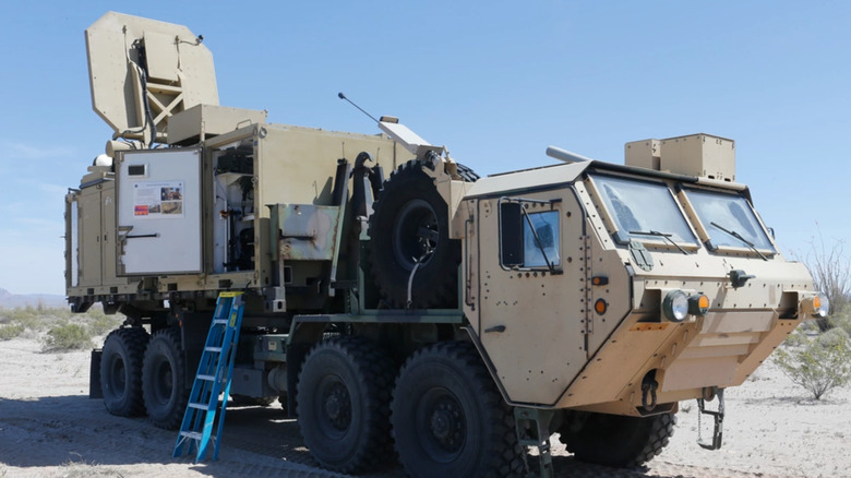 Active Denial System heat ray weapon on a military vehicle parked in the desert