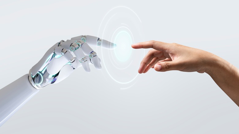 Robot and human hand touching.