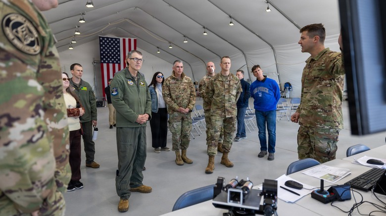 Leadership gathers during a briefing at the "Game of Drones" competition.