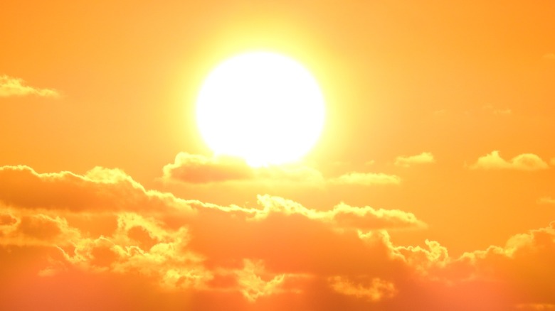 Sun blazing with clouds