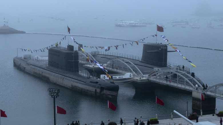 chinese flag alongside a large submarine
