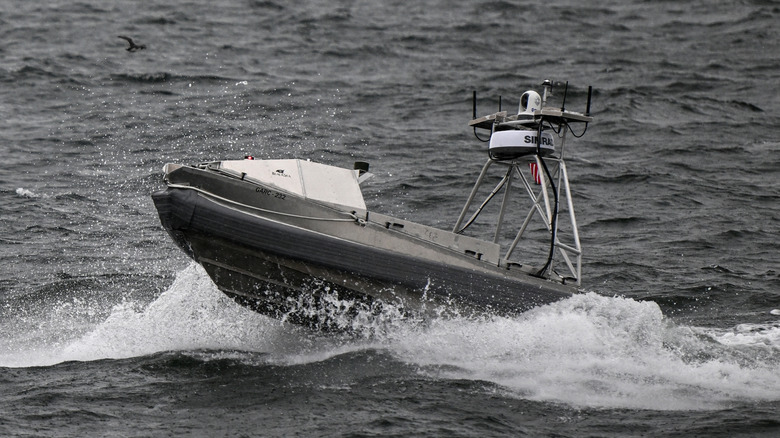 Close up view of unmanned U.S. Navy drone vessel cresting a wave during training mission.