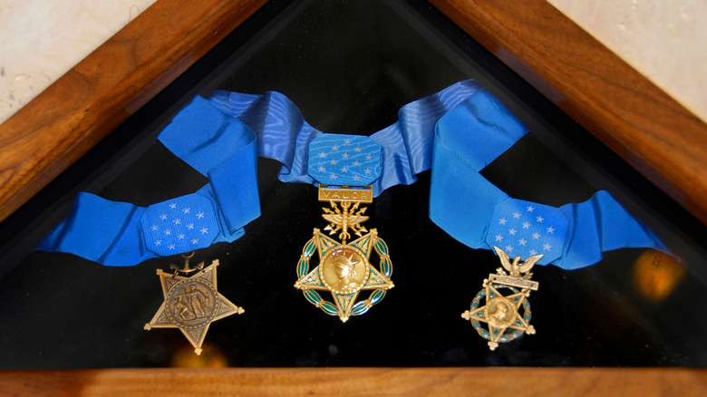 A Congressional Medal of Honor on display in wooden triangular box