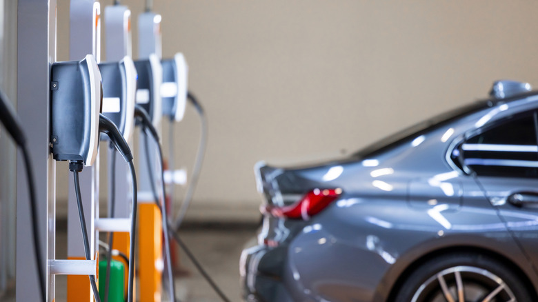 A car parked at an EV charging station.