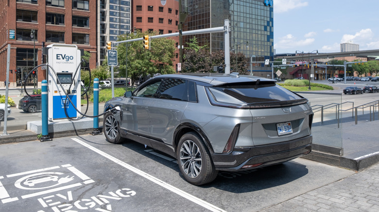 A car parked by an EV charger.