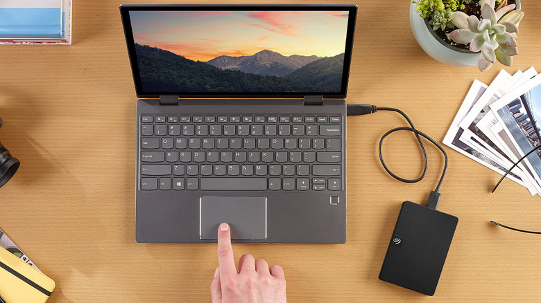 Laptop on a desk with hard drive connected