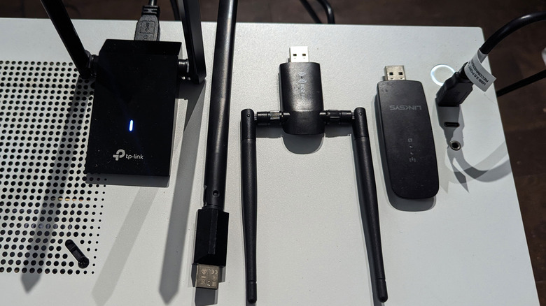 a collection of Wi-Fi network adapters on top of a PC